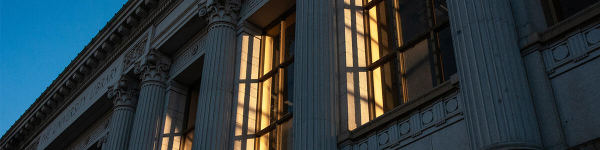 Evening sun lights up the windows of the Doe Library.